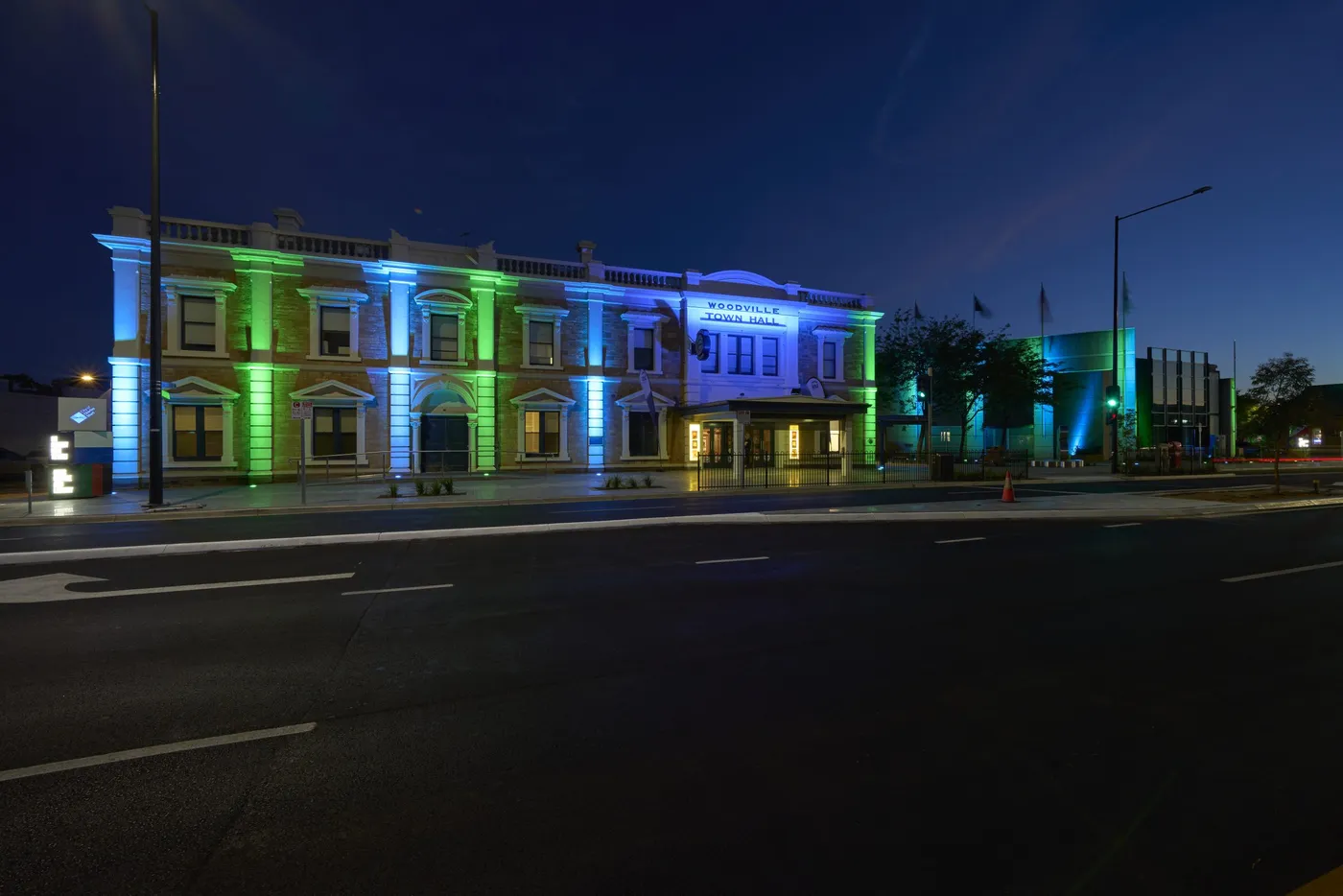 Woodville Town Hall lit in green and blue